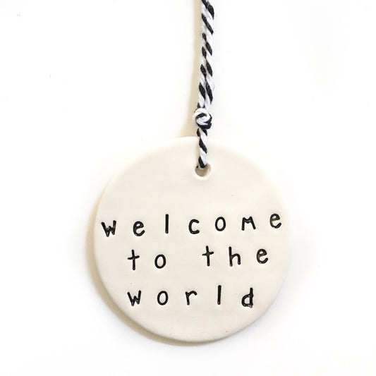 Handmade ceramic tag circle 'welcome to the world'