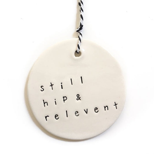 Handmade ceramic tag circle 'still hip & relevant'
