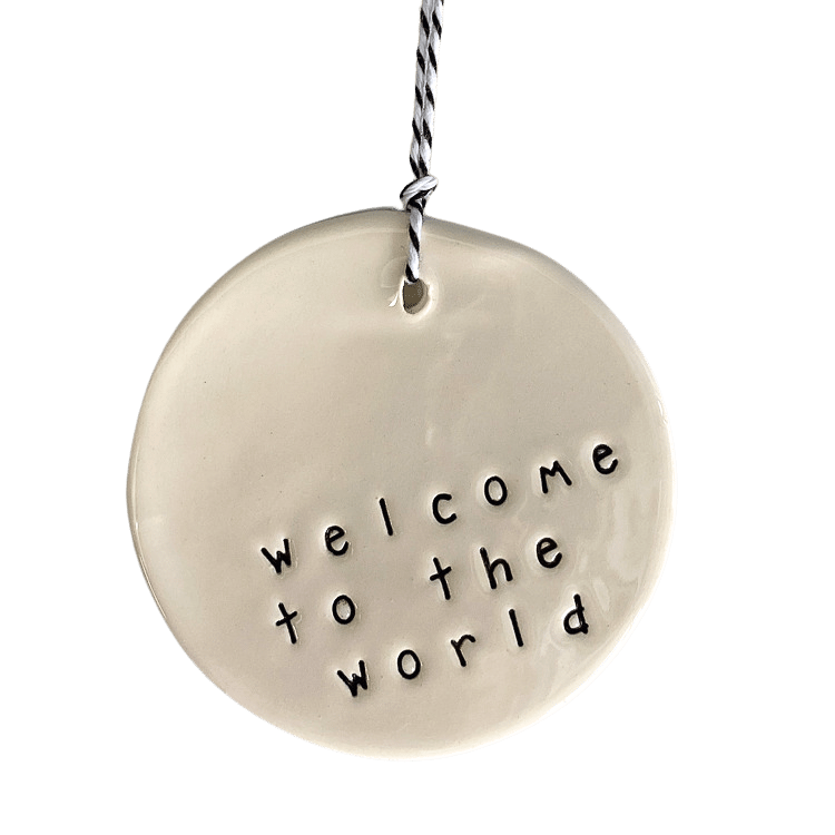 Handmade ceramic tag circle 'welcome to the world'